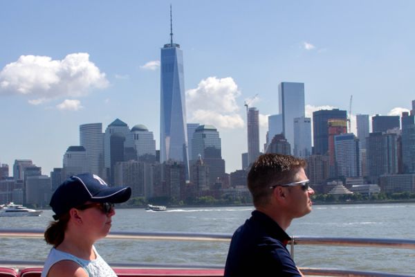 A man and woman on the cruise Line in front of the freedom tower