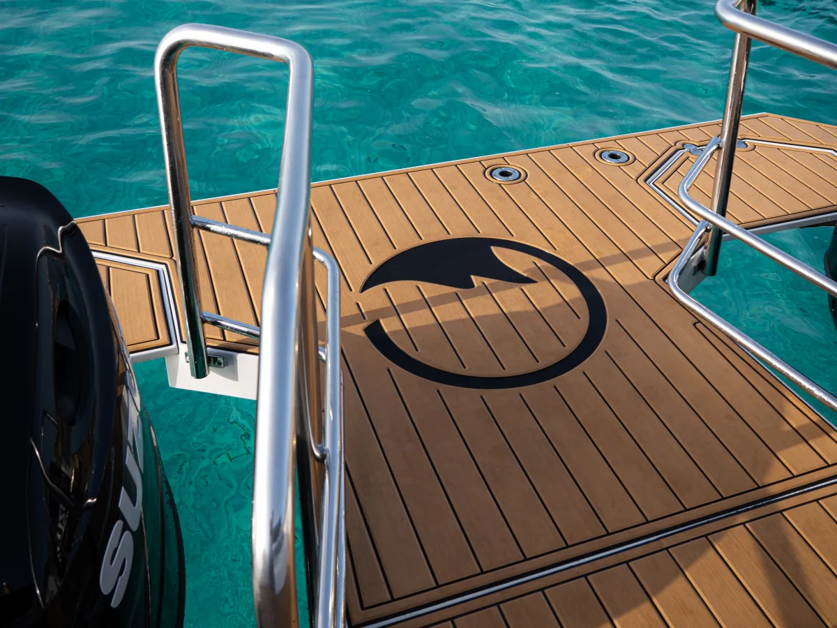 Teak swim platform with a ladder down to the water