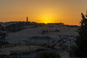 The sun peeking over the hill