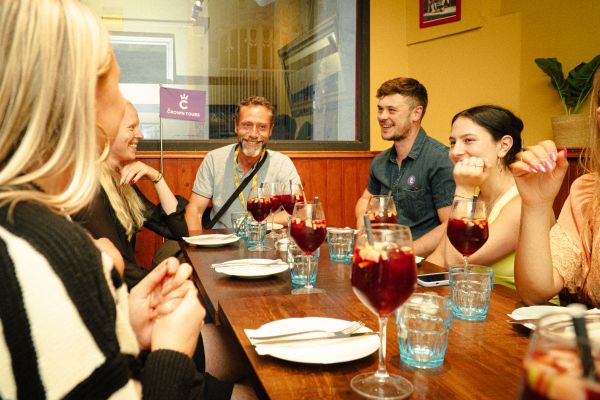 Guide explaining Barcelona's culinary traditions to a group during a food tour.