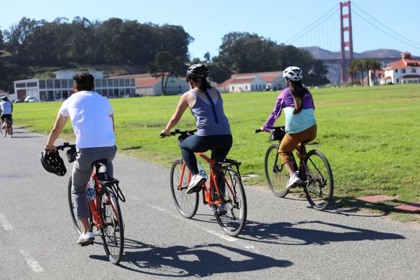 Two ladies and a guy on the Golden Gate Bridge All Day Bike Rental