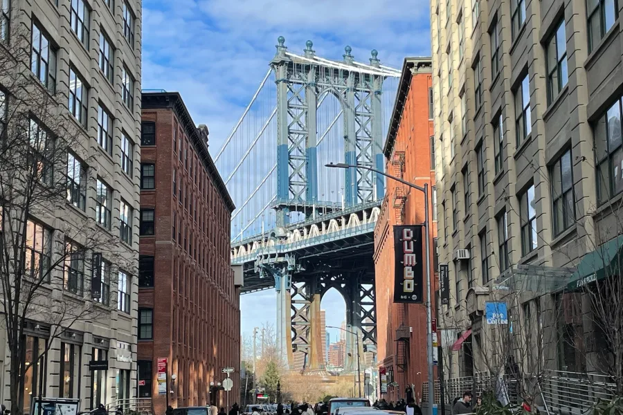 Brooklyn bridge seen between buildings on DUMBO tour