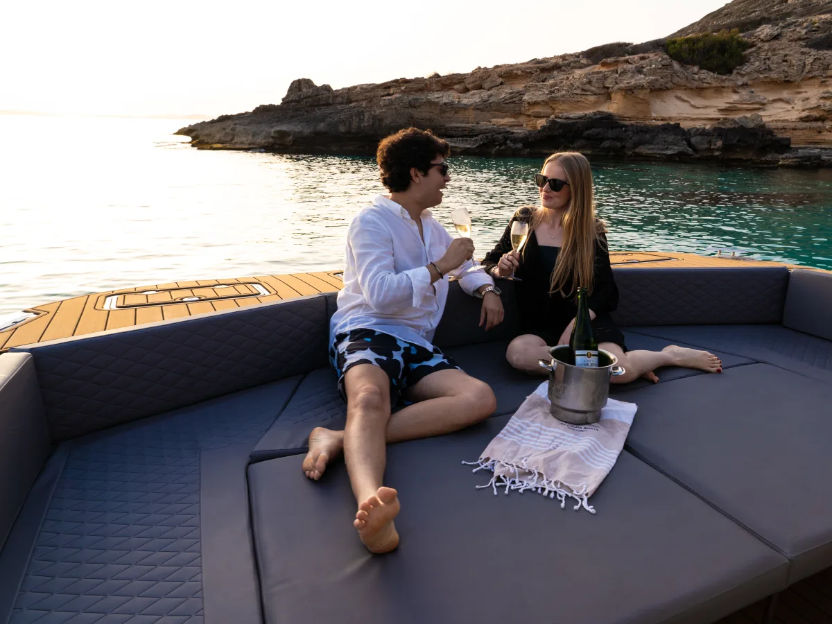 Couple toasting on the boat's bow sundeck