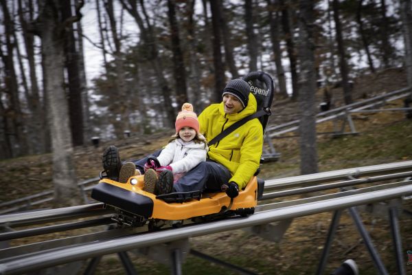 A man and his daughter on the Rocky Top Mountain Coaster