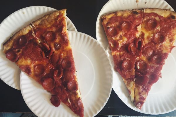 Having a Pizza Slice at the Food On Foot Go West Guided Tour