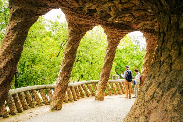 Stone pathways and green trees at Park Güell.