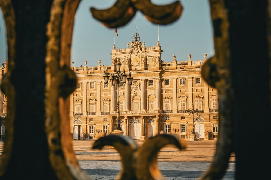View of the Royal Palace of Madrid through an ornate gate during Prado Museum & Royal Palace With a Historian experience