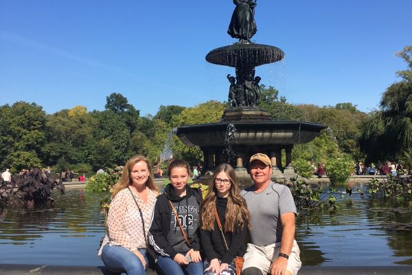 A family of 4 at the Bethesda Fountain