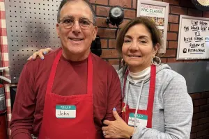 Couple posing with their made pizza