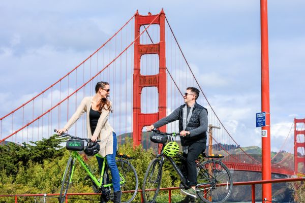 A couple on the Golden Gate Bridge All Day Bike Rental