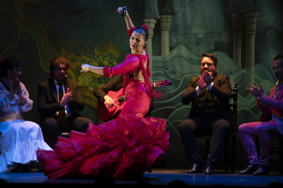 Female flamenco performer in red dancing during Private Flamenco show and dance class in Granada