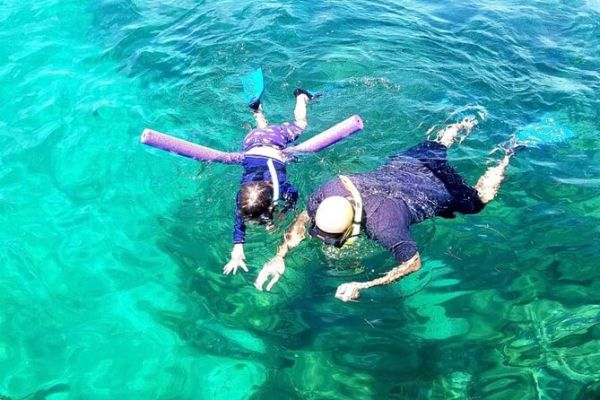 A man and girl snorkeling