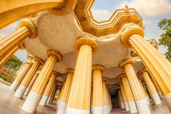 Park Güell columns with mosaic designs in Barcelona.