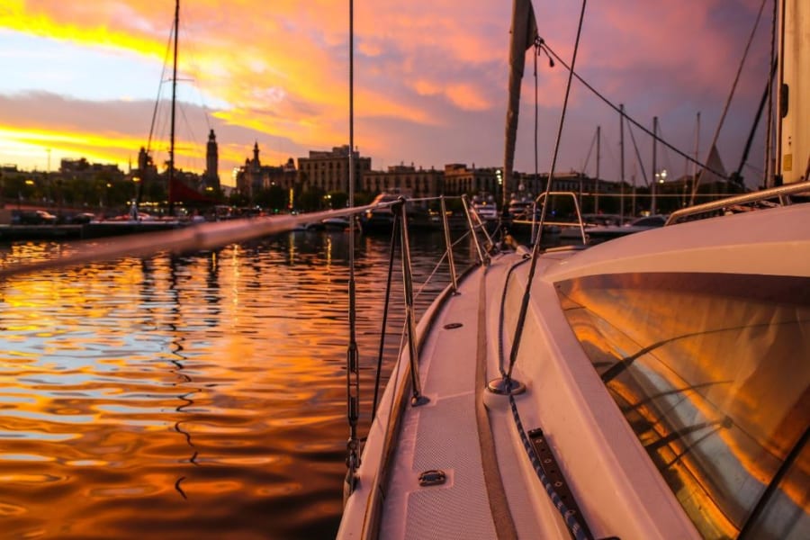 Side of yacht and waters during sunset