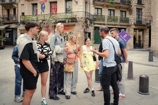 Tour group exploring the historic streets of Barcelona with a local guide.