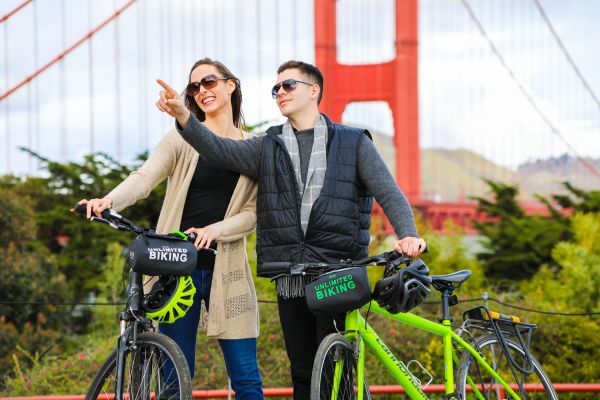 A man and a woman on the Golden Gate Bridge All Day Bike Rental