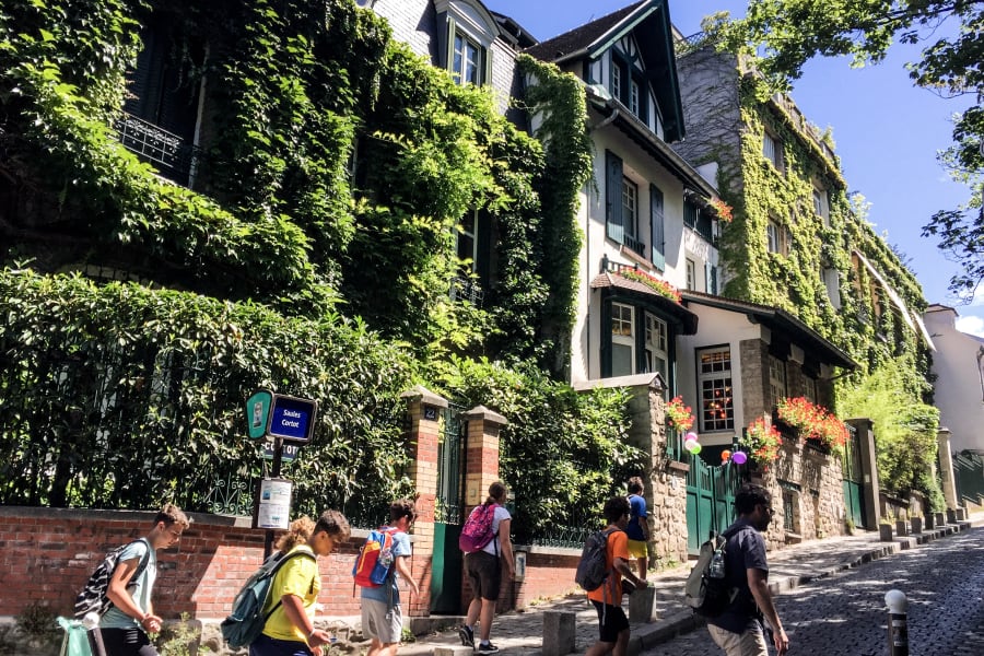 People walking through streets of Montmartre on a sunny day during private guided tour